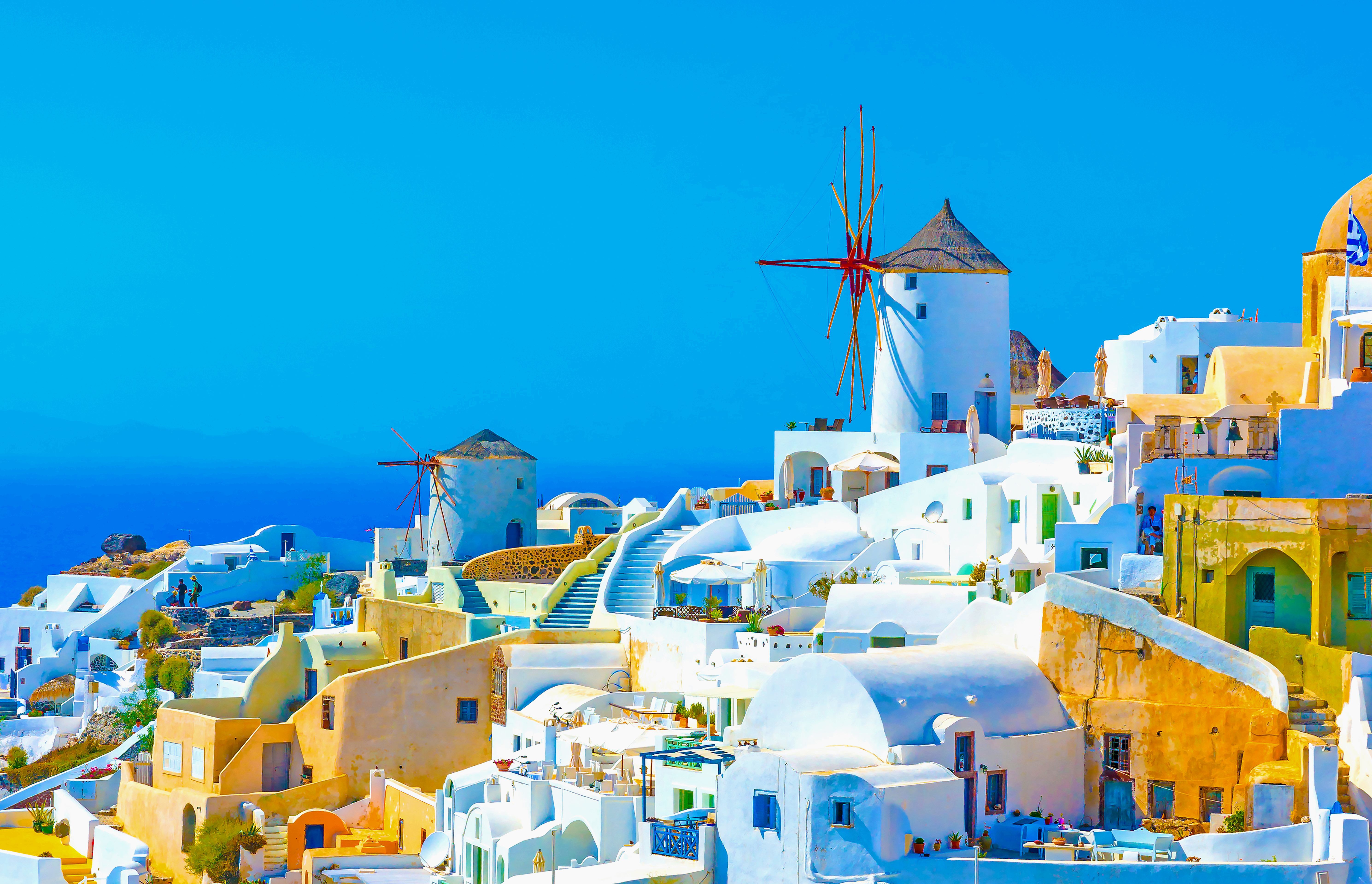 Panoramic view of windmills and houses in Oia, Santorini